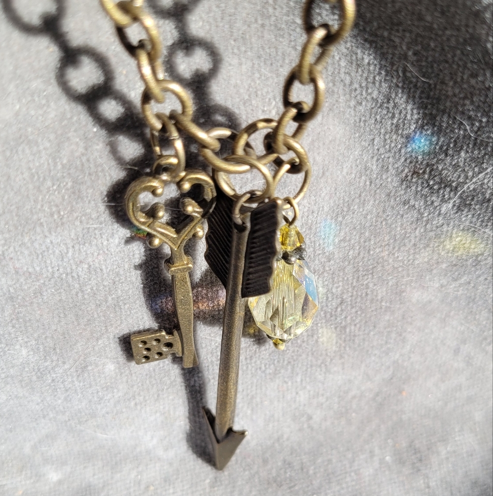 2/$12 Avon antique goldtone chain with arrow, skeleton key and crystal charms